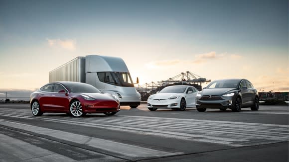 Tesla vehicles: three cars and a truck.