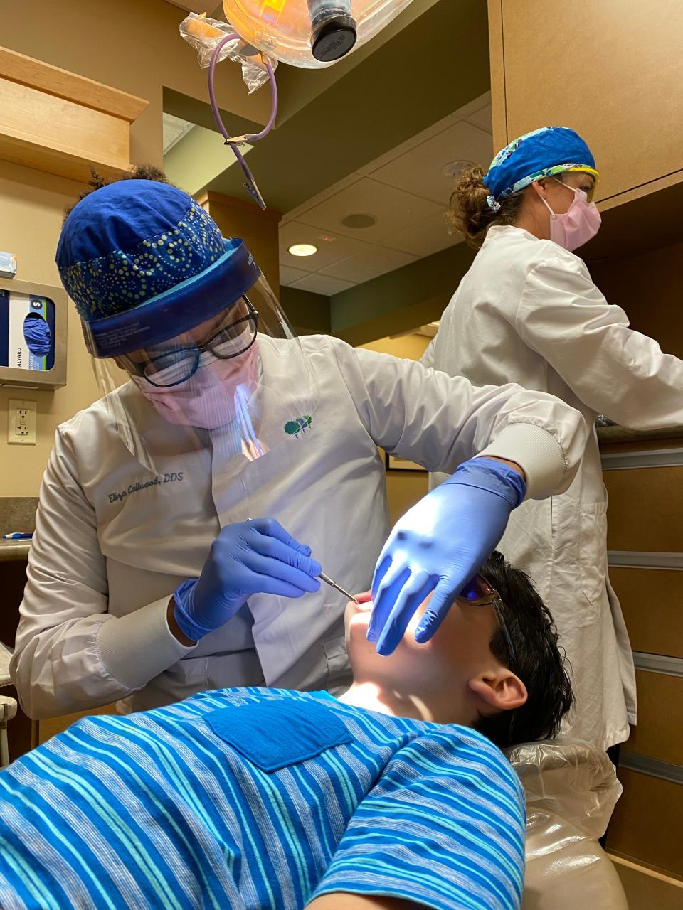 Dentist Eliza Callwood checks 10-year-old Xander Barton's teeth during a routine cleaning at Timberlane Dental in South Burlington on June 23, 2020.