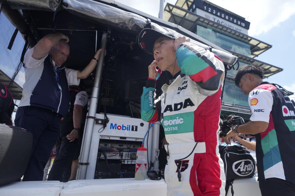 Takuma Sato, of Japan, stands on pit lane following a practice session for the Indianapolis 500 auto race at Indianapolis Motor Speedway, Friday, May 24, 2024, in Indianapolis. (AP Photo/Darron Cummings)