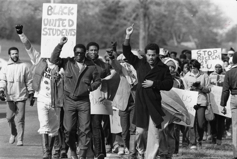 Members of Black United Students march October 27, 1979, down Summit Street from the Kent State Student Center to Dix Stadium to protest racism on campus and in athletics. Jeff Johnson, the BUS president, is in a black coat at the front of the march. Johnson served on Cleveland City Council and in the Ohio Senate.