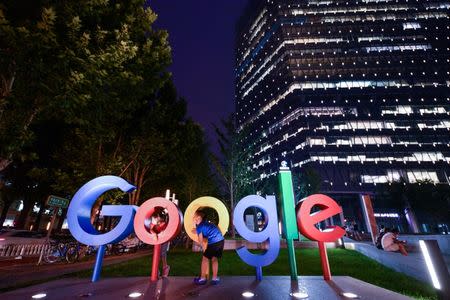 Children play around a sign of Alphabet Inc's Google outside its office in Beijing, China August 7, 2018. Picture taken August 7, 2018. REUTERS/Stringer REUTERS/Stringer