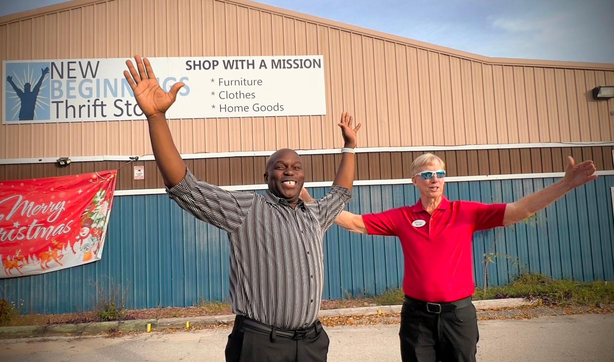 Jeremy Elliott, New Beginnings' community outreach manager, and Executive Director Steve Smith imitate the nonprofit's logo during a December 2023 visit to the organization's thrift store and offices.