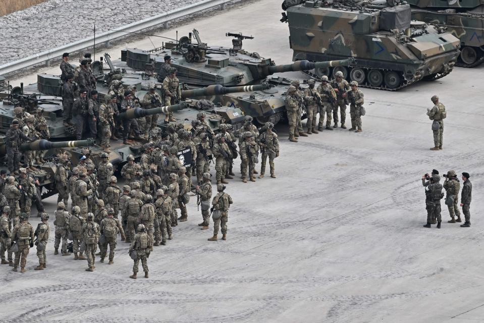 South Korean soldiers and US soldiers from the 2nd Infantry Division Stryker Battalion pose for a photo before a Warrior Shield live fire exercise at a military training field in Pocheon on March 22, 2023, as part of the Freedom Shield joint military exercise.