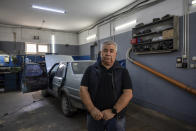 Oleksii, 68, director of the auto repair shop poses for photo in Kyiv region, Ukraine, Saturday, May 18, 2024. A divisive mobilisation law in Ukraine came into force on Saturday, as Kyiv struggles to boost troop numbers after Russia launched a new offensive. (AP Photo/Alex Babenko)