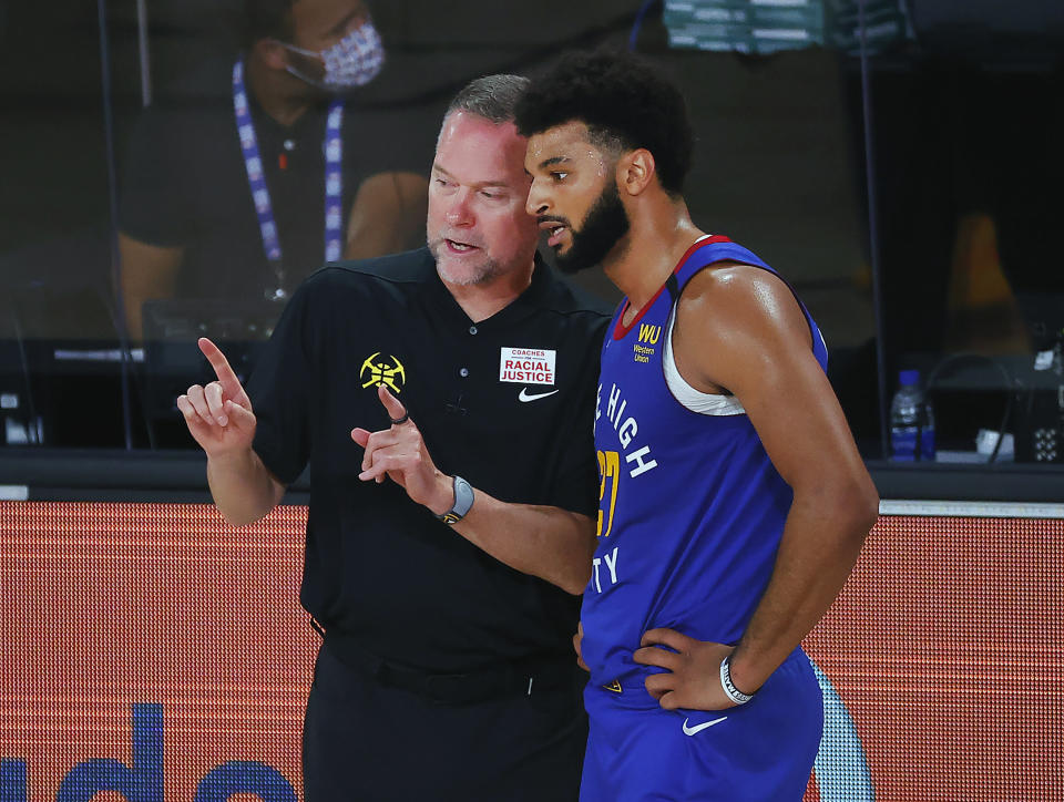 Denver Nuggets head coach Michael Malone talks with Jamal Murray during the third quarter against the Utah Jazz in an NBA basketball game Saturday, Aug. 8, 2020, in Lake Buena Vista, Fla. (Kevin C. Cox/Pool Photo via AP)