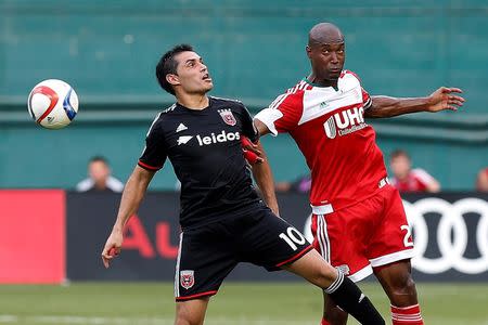 Jun 21, 2015; Washington, DC, USA; D.C. United forward Fabian Espindola (10) and New England Revolution defender Jose Goncalves (23) leap to head the ball in the second half at Robert F. Kennedy Memorial Stadium. D.C. United won 2-1. Geoff Burke-USA TODAY Sports