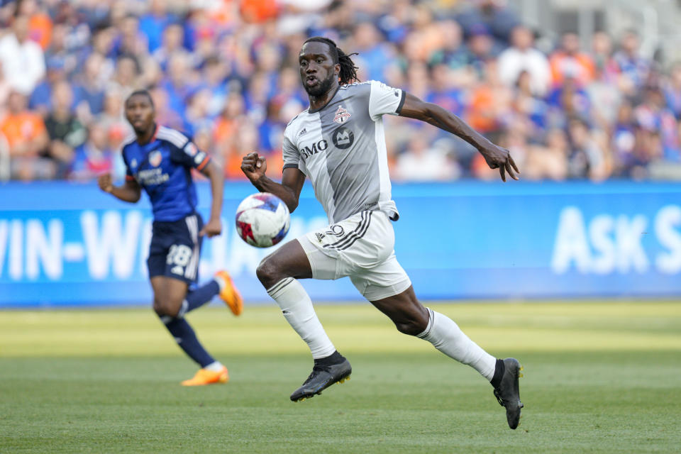 Toronto FC forward C.J. Sapong (9) chases a pass during the first half of the team's MLS soccer match against FC Cincinnati on Wednesday, June 21, 2023, in Cincinnati. (AP Photo/Jeff Dean)