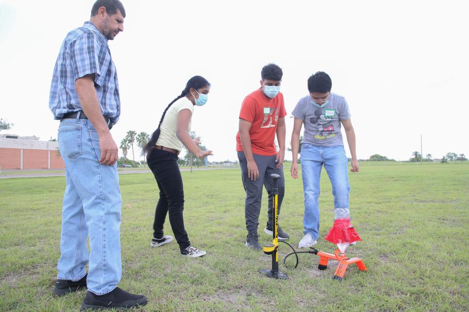 From the left, Nedal Shheber, associate professor of engineering and computer science at Del Mar College, and high school students Sai Varshini Chinnasani, Yadiel Escamilla and Raul Chavez step back after applying pressure into a homemade bottle rocket at Del Mar College's Windward Campus Saturday, June 4, 2022.