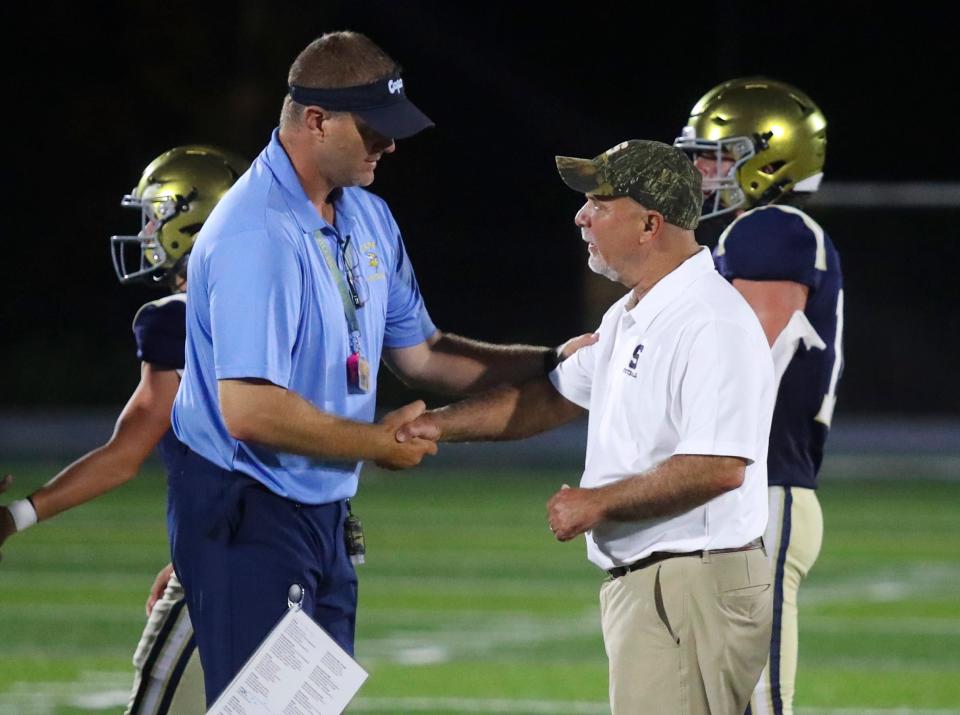 Cape Henlopen coach Mike Frederick (left) greets Salesianum coach Bill DiNardo after a 28-21 Sallies victory on Sept. 1, 2022. It was Frederick's first game as head coach of the Vikings, who will meet the Sals again more than a year later - in the DIAA Class 3A championship game at 7 p.m. Friday at Delaware Stadium.