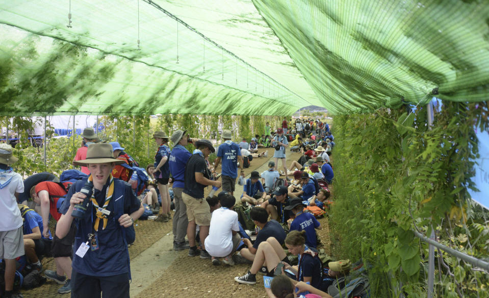 Attendees of the World Scout Jamboree rest in the shade at a scout camping site in Buan, South Korea, Friday, Aug. 4, 2023. More than 4,000 British Scouts will leave the World Scout Jamboree at a campsite in South Korea and move into hotels this weekend, the U.K. Scout Association said Friday, as concerns grow after more than 100 participants were treated for heat-related ailments. (Kim-yeol/Newsis via AP)