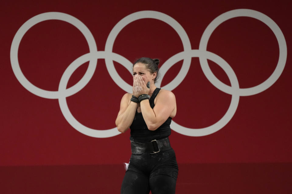 Maude G. Charron of Canada cries after the last lift in the women's 64kg weightlifting event, at the 2020 Summer Olympics, Tuesday, July 27, 2021, in Tokyo, Japan. (AP Photo/Luca Bruno)