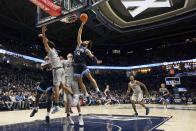 Villanova's Caleb Daniels (14) shoots over Xavier's Jack Nunge (24) during the second half of an NCAA college basketball game, Wednesday, Jan. 12, 2022, in Cincinnati. (AP Photo/Jeff Dean)