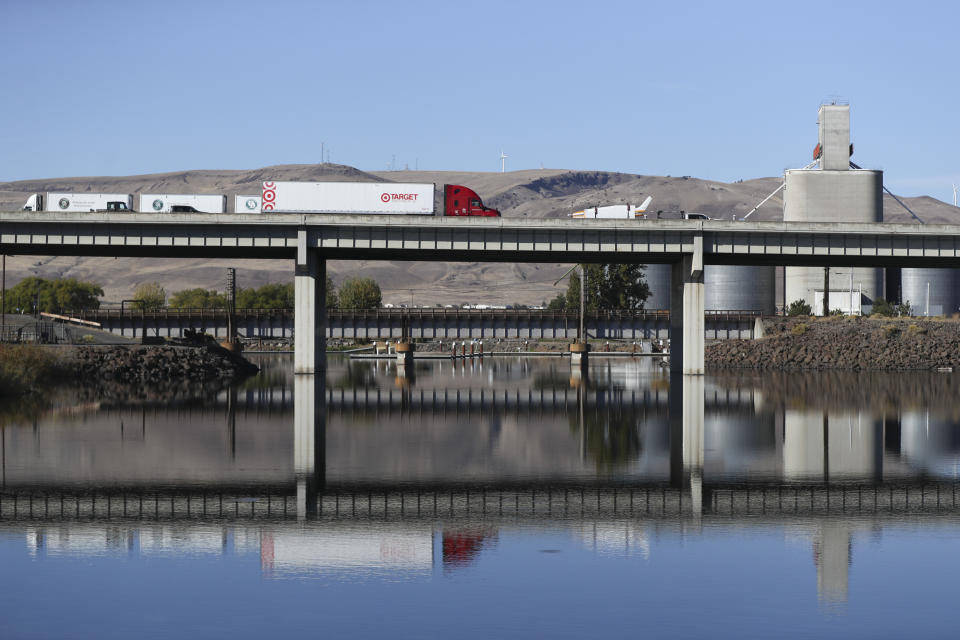 Trucks drive along I-5 through Arlington, Ore., Wednesday, Oct. 18, 2023. Arlington is home to Najiah Knight, a high school junior who is on a yearslong quest to become the first woman to compete at the top level of the Professional Bull Riders tour. (AP Photo/Amanda Loman)