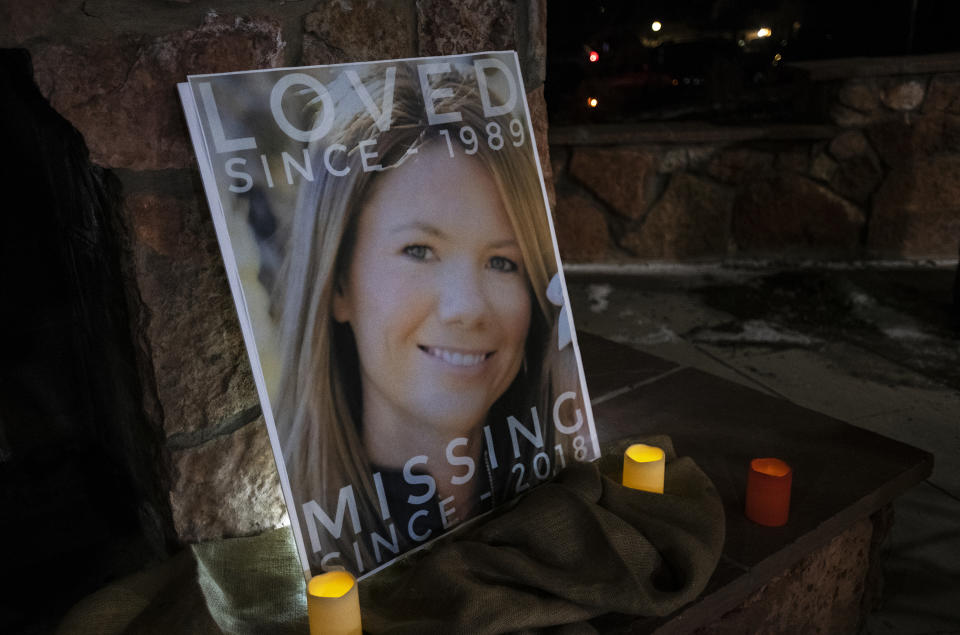 A poster with the picture of the missing Kelsey Berreth is propped up with candles for a vigil Memorial Park in Woodland Park, Colo., on Thursday, Dec. 13, 2018. (Kelsey Brunner/The Gazette via AP)