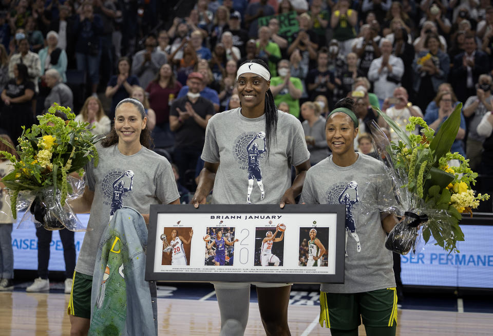 Seattle Storm guard Sue Bird, left, Minnesota Lynx center Sylvia Fowles, center, and Storm guard Briann January are honored before a WNBA basketball game Friday, Aug. 12, 2022, in Minneapolis. (Elizabeth Flores/Star Tribune via AP)