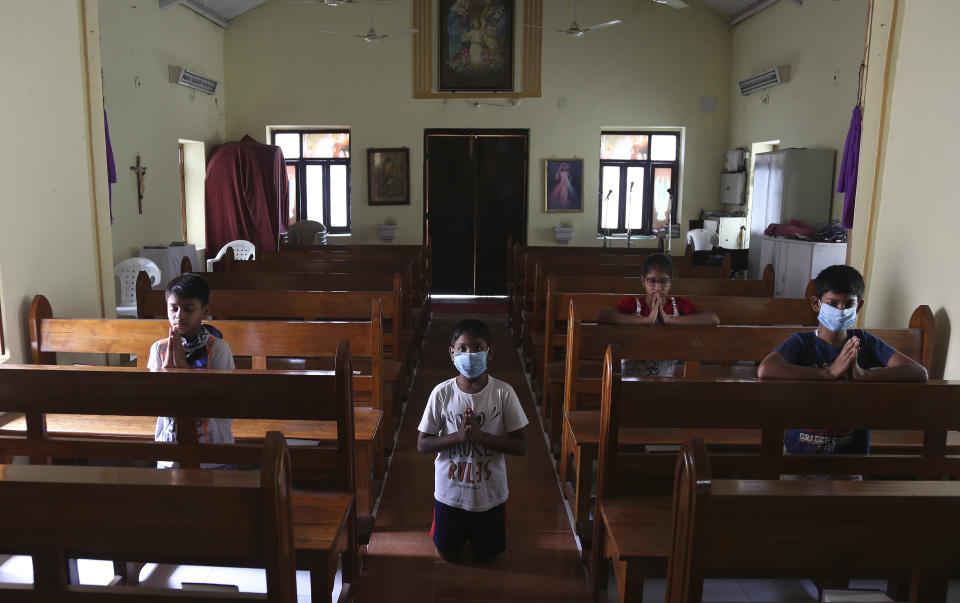 Catholic devotees offer prayers at Our Lady of Lourdes Church on Good Friday, during a lockdown to control the spread of the coronavirus in Hyderabad, India, Friday, April 10, 2020. (AP Photo/Mahesh Kumar A.)