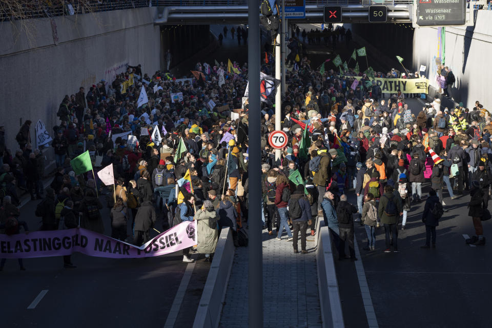 Extinction Rebellion activists and sympathisers block a busy road in The Hague, Netherlands, Saturday, Jan. 28, 2023. Earlier this week seven Extinction Rebellion activists were detained by authorities for sedition linked to the protest. (AP Photo/Peter Dejong)