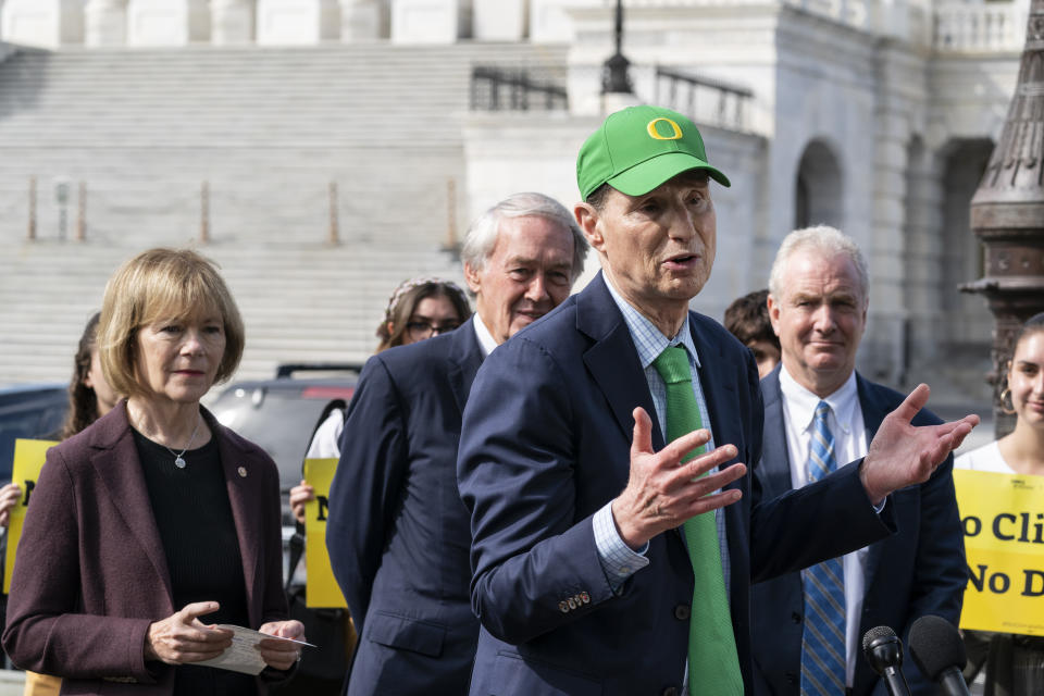 Sen. Ron Wyden, D-Ore., third from left, speaks about climate change, accompanied by Sen. Tina Smith, D-Minn., left, Sen. Ed Markey, D-Mass., and Sen. Chris Van Hollen, D-Md., during a news conference on Capitol Hill, Thursday, Oct. 7, 2021, in Washington. (AP Photo/Alex Brandon)