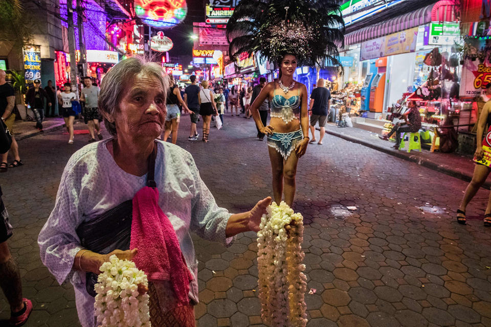 Elderly woman offering garlands