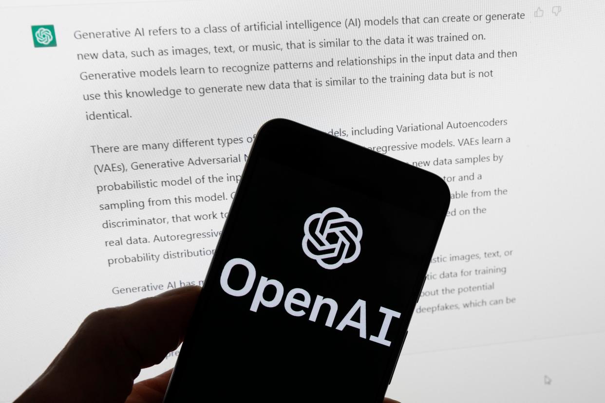 The OpenAI logo is seen on a mobile phone in front of a computer screen displaying output from ChatGPT, March 21, 2023, in Boston. The U.S. Federal Trade Commission has launched an investigation into ChatGPT creator OpenAI and whether the artificial intelligence company violated consumer protection laws by scraping public data and publishing false information through its chatbot, according to reports in the Washington Post and the New York Times.