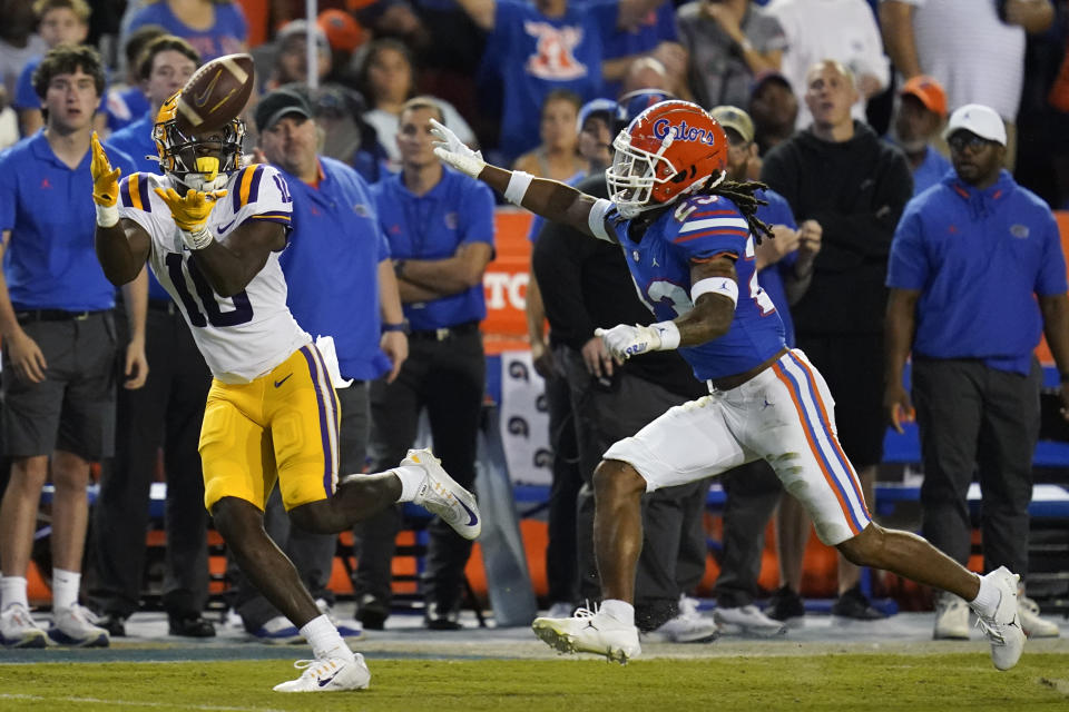 LSU wide receiver Jaray Jenkins, left, makes a reception in front of Florida cornerback Jaydon Hill for a 54-yard touchdown during the first half of an NCAA college football game, Saturday, Oct. 15, 2022, in Gainesville, Fla. (AP Photo/John Raoux)