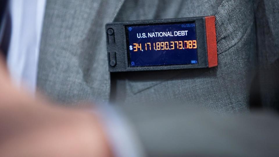 PHOTO: Rep. Thomas Massie wears a miniature national debt clock during a meeting of the House Rules Committee, in Washington, D.C., on Feb. 5, 2024. (Allison Bailey/NurPhoto via Shutterstock)