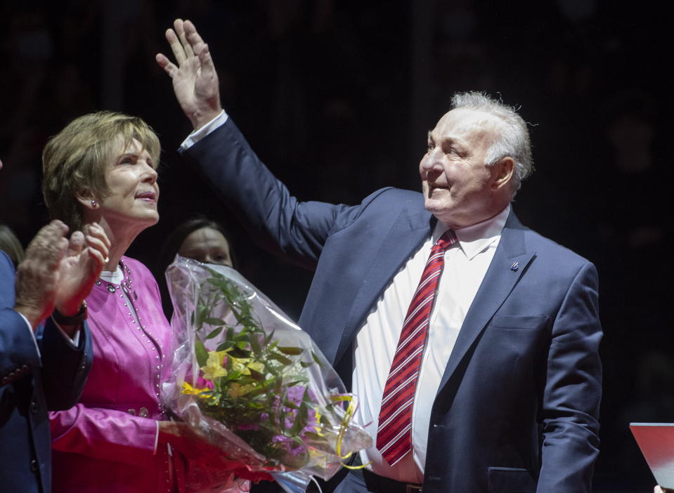 NHL hockey legend Guy Lafleur waves to fans as his wife Lise looks on during a ceremony to honor him, Thursday, October 28, 2021, at the Videotron Centre in Quebec City. Montreal Canadiens legend Guy Lafleur has died at age 70. (Jacques Boissinot/The Canadian Press via AP)