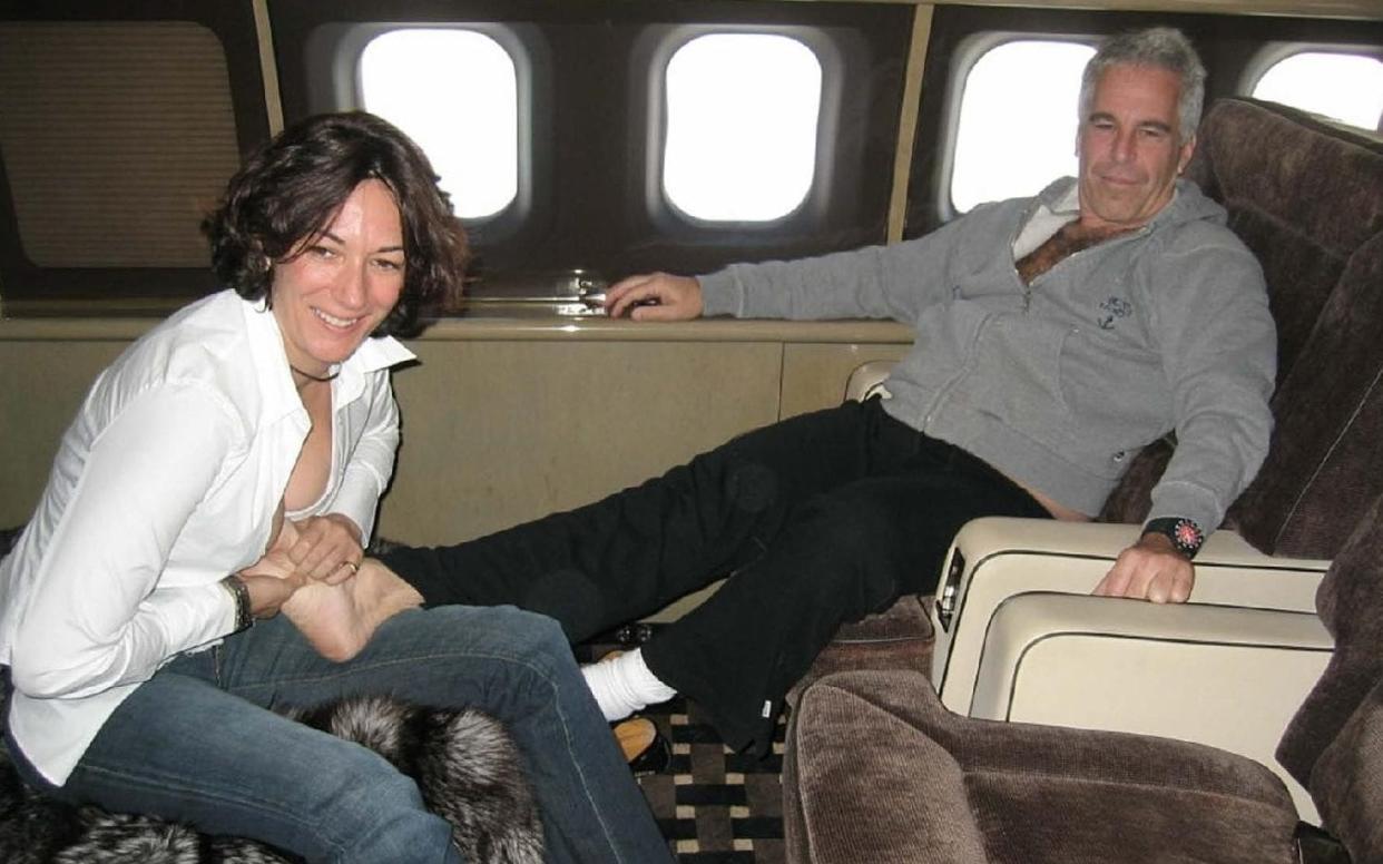 Undated handout photo issued by US Department of Justice shows Ghislaine Maxwell massaging Jeffrey Epstein's foot on a private jet - US Department of Justice