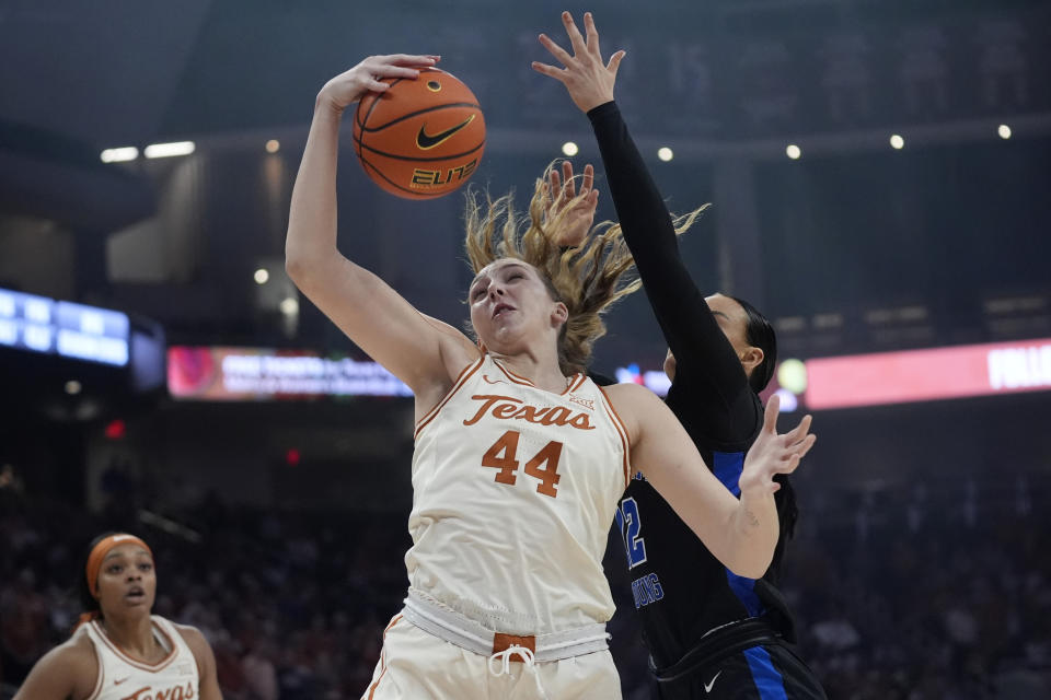 Texas forward Taylor Jones (44) grabs a rebound in front of BYU forward Lauren Gustin, right, during the first half of an NCAA college basketball game in Austin, Texas, Saturday, March 2, 2024. (AP Photo/Eric Gay)