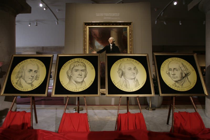 The designs of a new series of circulating presidential $1 coins are pictured during a presentation at the National Portrait Gallery in Washington on October 15, 2006. On April 2, 1792, Congress passed legislation authorizing the U.S. Mint to coin money, all to be inscribed with the Latin words "E Pluribus Unum," a motto meaning "Out of Many, One." File Photo by Yuri Gripas/UPI