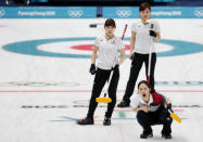 Curling - Pyeongchang 2018 Winter Olympics - Women's Semi-final - South Korea v Japan - Gangneung Curling Center - Gangneung, South Korea - February 23, 2018 - Vice-skip Kyeongae Kim of South Korea shouts as lead Yurika Yoshida of Japan and vice-skip Chinami Yoshida of Japan look on . REUTERS/Cathal McNaughton