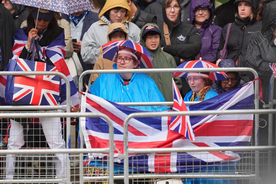 Crowds waiting to see the Royal Family became increasingly soaked as the procession went on (James Manning/PA Wire)