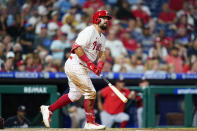 Philadelphia Phillies' Kyle Schwarber follows through after hitting a home run against Washington Nationals pitcher Josiah Gray during the sixth inning of a baseball game, Wednesday, July 6, 2022, in Philadelphia. (AP Photo/Matt Slocum)