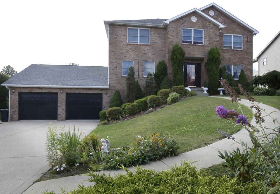 FILE - In this file photo from Aug. 19, 2013, the home of Eileen Battisti is seen in her neighborhood in Aliquippa, Pa. Beaver County Common Pleas Judge Gus Kwidis ruled April 22, 2014, to turn down Battisti's request to reverse the sale of her $280,000 house at a tax auction three years ago over $6.30 in unpaid interest. (AP Photo/Keith Srakocic, File)