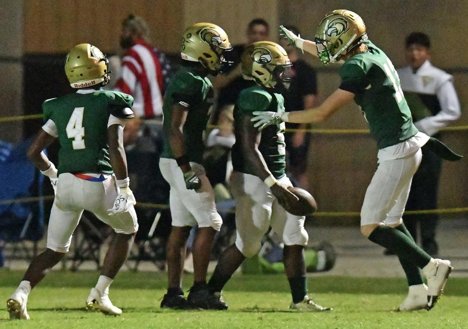 Fleming Island players celebrate a long touchdown run by Tyler Beverly (5). The Golden Eagles travel to Creekside in District 3-4S football.