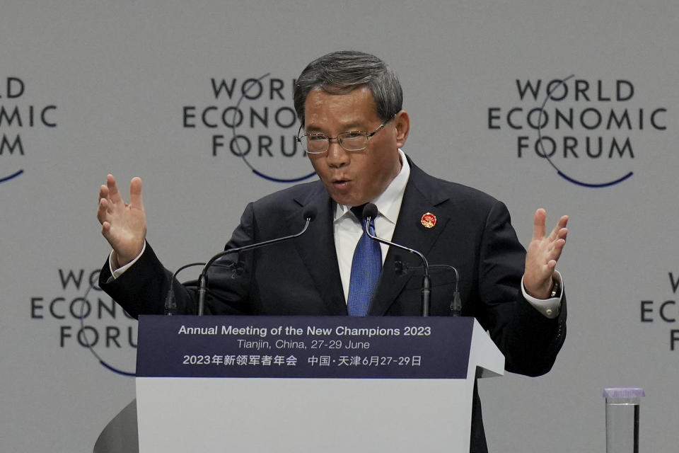 Chinese Premier Li Qiang gestures as he delivers his opening speech for the World Economic Forum's Annual Meeting of the New Champions 2023, also known as the Summer Davos, at the Meijiang Convention and Exhibition Center in northern China's Tianjin Municipality, Tuesday, June 27, 2023. (AP Photo/Andy Wong)