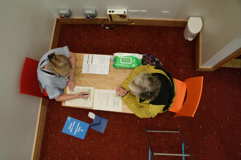 A woman talks to a healthcare worker before she receives an injection of a Covid-19 vaccine at the NHS vaccine centre that has been set up at the Centre for Life in Times Square, Newcastle. The centre is one of the seven mass vaccination centres now opened to the general public as the government continues to ramp up the vaccination programme against Covid-19. (Photo by Owen Humphreys/PA Images via Getty Images)