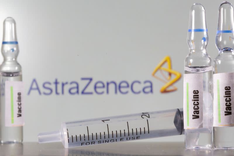 FILE PHOTO: A test tube labelled with the Vaccine is seen in front of AstraZeneca logo in this illustration taken