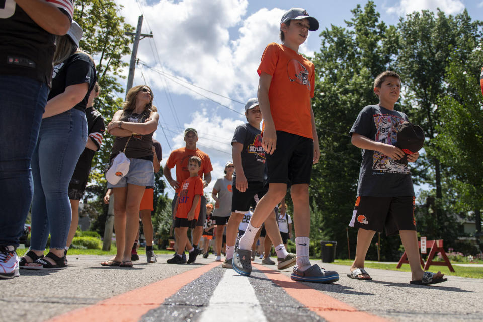 Cleveland Browns fans wait to enter the team facility before an NFL football practice in Berea, Ohio, Saturday, July 30, 2022. (AP Photo/David Dermer)