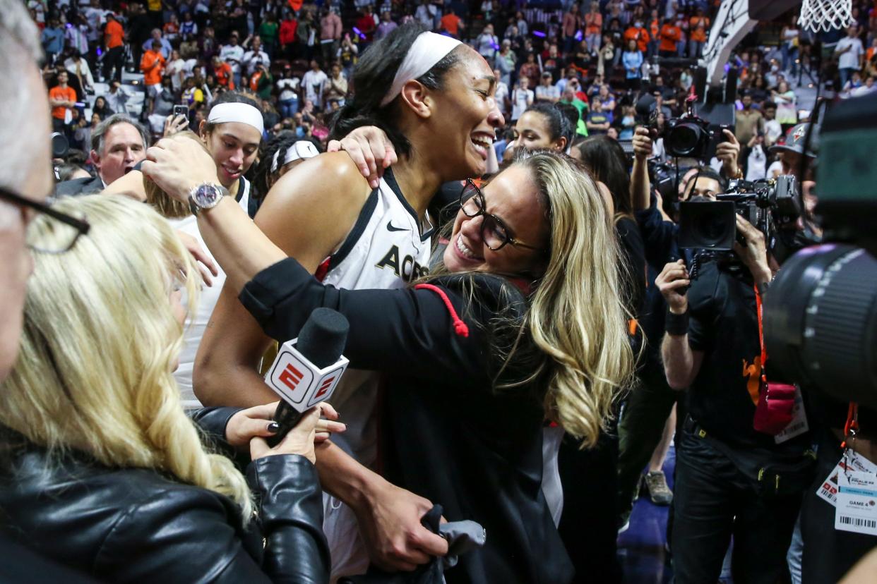 Aces forward A'ja Wilson celebrates with coach Becky Hammon after winning the WNBA championship on Sunday.
