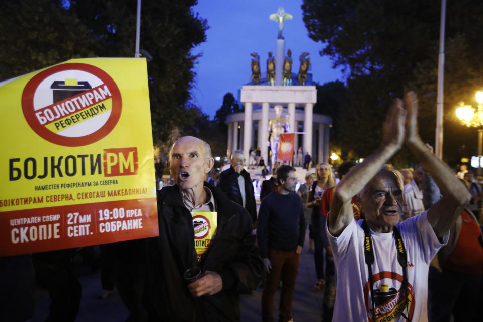 Backdropped by the Parliament, protesters that had urged voters to boycott Sunday's referendum chant slogans as they demonstrate in Skopje, Macedonia, Sunday, Sept. 30, 2018. A crucial referendum on changing the nation of Macedonia's name to North Macedonia to pave the way for NATO membership attracted tepid voter participation Sunday. (AP Photo/Thanassis Stavrakis)