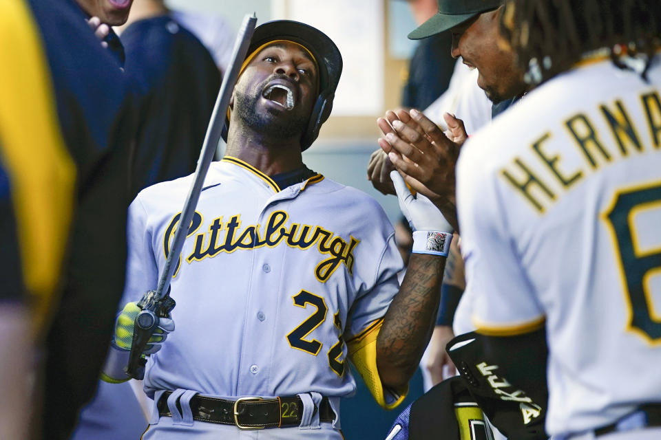 FILE - Pittsburgh Pirates' Andrew McCutchen holds the team's home run sword as he celebrates in the dugout with teammates after hitting a solo home run against the Seattle Mariners Friday, May 26, 2023, in Seattle. About half the clubs in MLB are using some kind of prop or ritual to celebrate a big hit or a big play in ways that often go viral. (AP Photo/Lindsey Wasson, File)