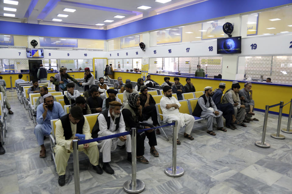 Afghans wait to receive their posts in the main post office in the city of Kabul, Afghanistan, Wednesday, July 3, 2024. In parts of Afghanistan where there are no street names or house numbers, utility companies and their customers have adopted a creative approach for connecting. They use mosques as drop points for bills and cash, a "pay and pray" system. (AP Photo/Siddiqullah Alizai)