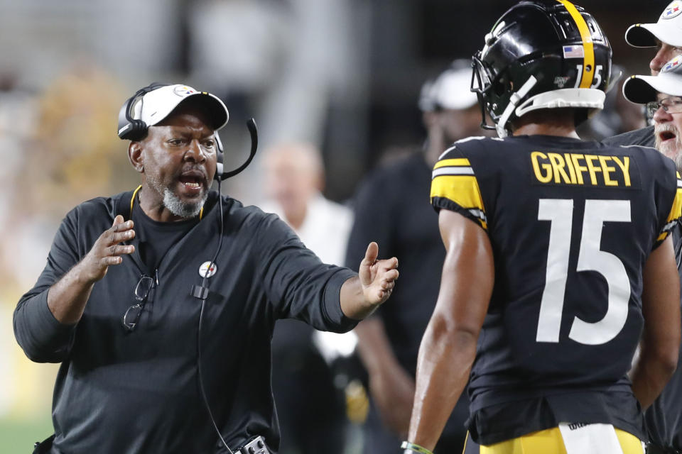 In this photo from Friday, Aug. 9, 2019, Pittsburgh Steelers wide receivers coach Darryl Drake, left talks to wide receiver Trey Griffey (15) during the second half of an NFL preseason football game against the Tampa Bay Buccaneers in Pittsburgh. The team said Drake, who joined the coaching staff in 2018, died early Sunday morning, Aug. 12, 2019. (AP Photo/Keith Srakocic)
