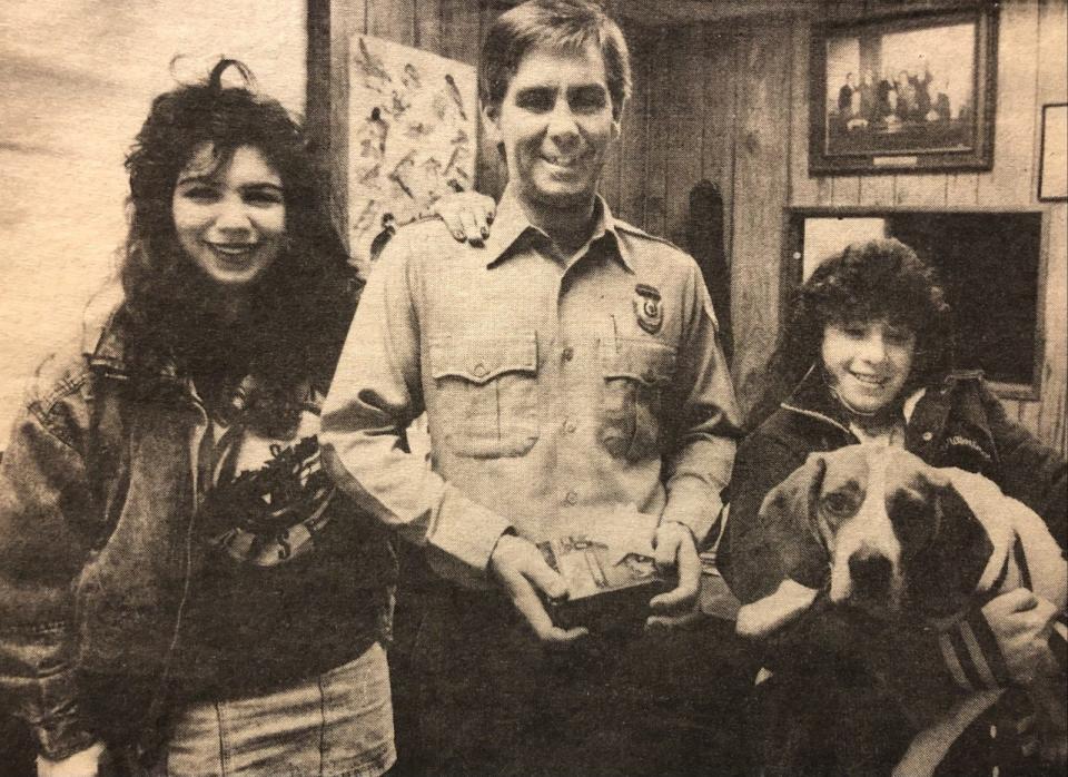 On March 1, 1989, Sean Cleaves, ranger at Pond Meadow Park in Braintree, receives a thank you gift from two young girls who fell through the ice on the pond two days earlier on Feb. 27, and were rescued by Cleaves and the town fire department. Allison Asci, left, 11, and Nicole Caruso, right, 12, and her dog.