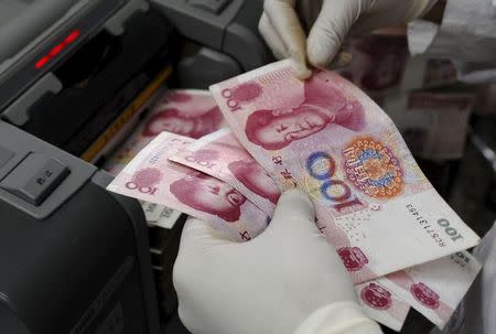 A staff member counts Renminbi (RMB) banknotes at a branch of Bank of China in Changzhi, Shanxi province in this September 16, 2008 file photo. REUTERS/Stringer/Files