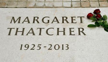 A rose lays on the memorial stone of former Prime Minister Margaret Thatcher, in the grounds of the the Royal Hospital Chelsea, marking the spot where her ashes were laid to rest following a service in London September 28, 2013. REUTERS/John Stillwell/Pool