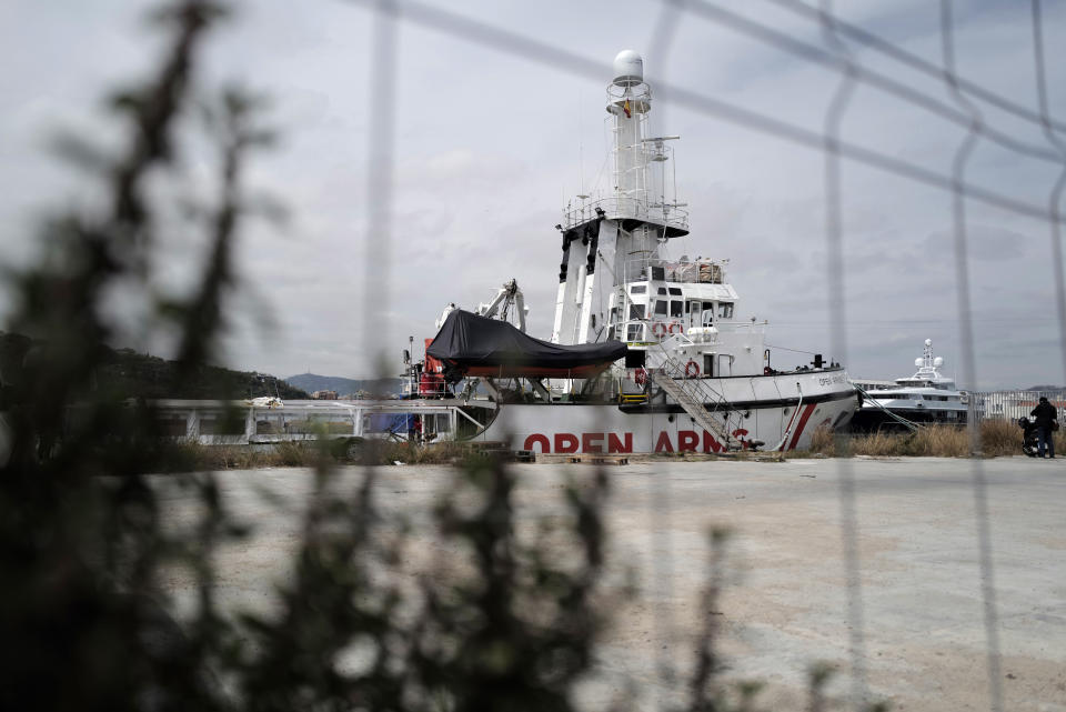 FILE - In this Wednesday April 17, 2019 file photo, The Proactiva's Open Arms rescue boat sits docked in Barcelona, Spain. A judge in Sicily has dropped an investigation against two member of the Spanish aid group Proactiva Open Arms deriving from a tense high-seas standoff last year when the crew refused to hand over 218 migrants rescued at sea to the Libyan coast guard. Proactiva welcomed the decision to drop the investigation into criminal association and aiding illegal migration Wednesday, calling it ‘’an additional step toward the truth.’’ The group stated that it has always operated according to international roles. (AP Photo/Renata Brito)