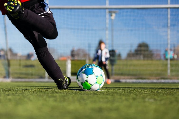 A player taking a penalty kick