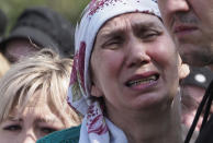 A woman cries during the funeral of Elvira Ignatieva, an English language teacher who was killed at a school shooting on Tuesday in Kazan, Russia, Wednesday, May 12, 2021. Russian officials say a gunman attacked a school in the city of Kazan and Russian officials say several people have been killed. Officials said the dead in Tuesday's shooting include students, a teacher and a school worker. Authorities also say over 20 others have been hospitalised with wounds. (AP Photo/Dmitri Lovetsky)